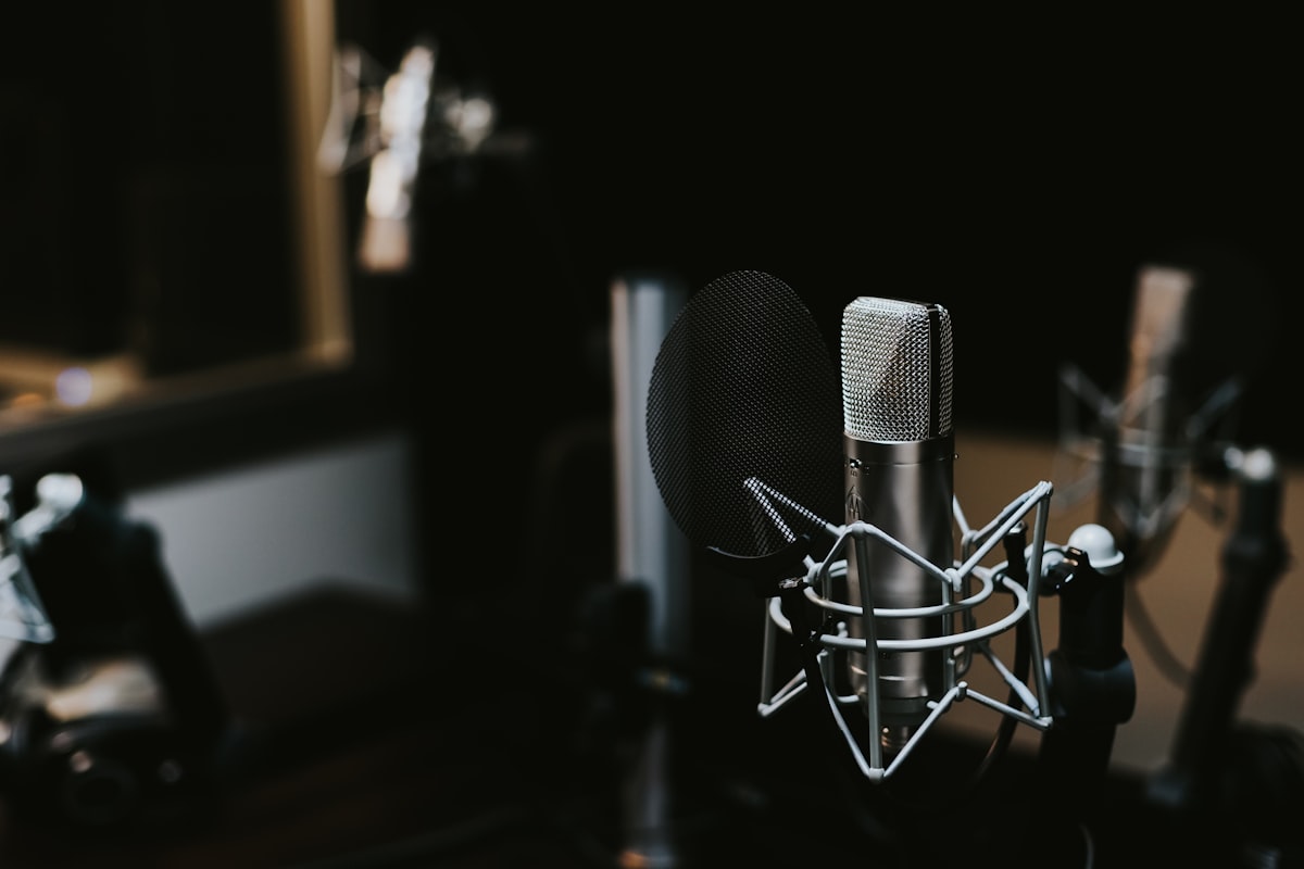 Microphone on a desk beside printed briefing notes